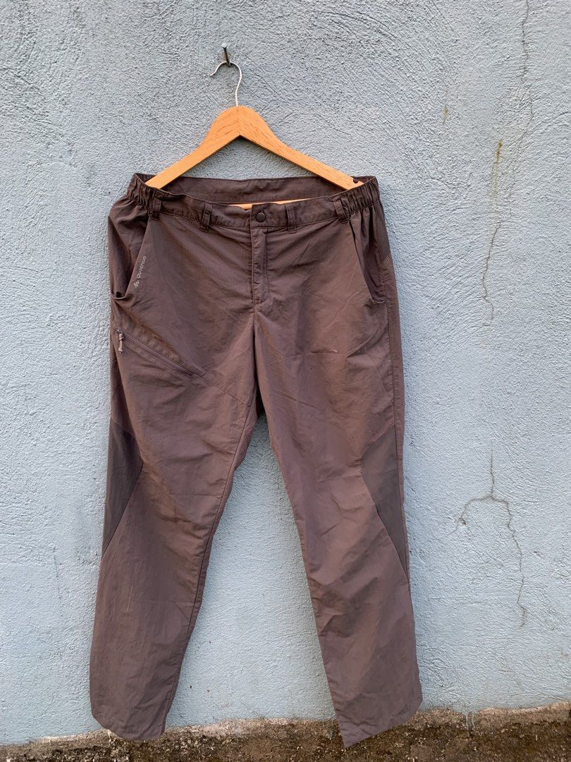 Quechua Hiking Trousers Brown (Category: Trousers) located in Manila. Submitted by rommelx-07 (Listing ID 1470255533, Image 1). Description: Quechua outdoor trekking trousers in dark brown. Elastic waistband with belt loops, zip pocket on the right thigh, and reinforced panel details. Note there is a small hole near the front thigh area and some wear on the inner brand tag. Lightweight synthetic fabric..