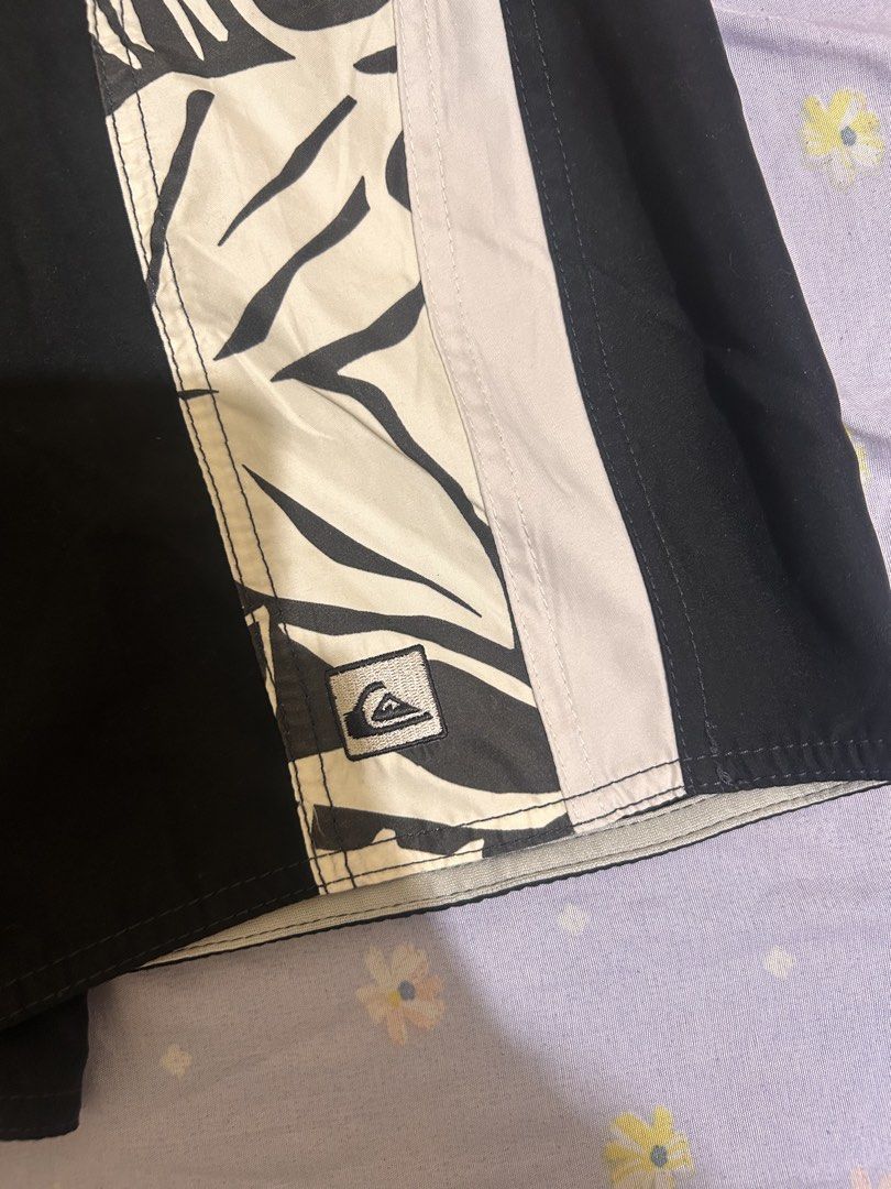 Quiksilver Black White Tropical Leaf Board Shorts (Category: Swim Trunks & Board Shorts) located in Manila. Submitted by luckystorm.219744 (Listing ID 1470298325, Image 2). Description: - Authentic Quiksilver board shorts in black and off-white - Stylish contrast side panel with a bold tropical leaf pattern - Iconic embroidered Quiksilver logo patch near the hem - Comfortable elastic waistband with adjustable drawstring closure - Lightweight, qui