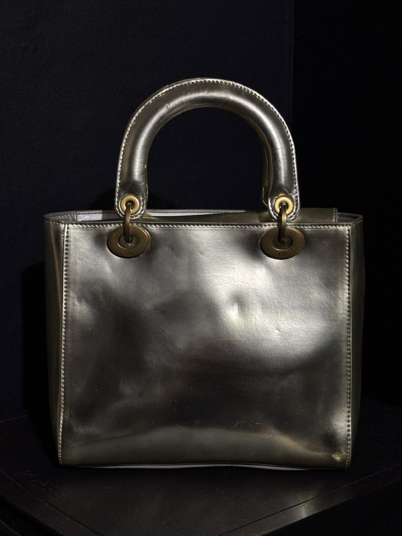 RARE CHRISTIAN DIOR LADY DIOR METALLIC SILVER (Category: Luxury Bags & Wallets) located in Quezon City. Submitted by qr8d.ph (Listing ID 1470201788, Image 2). Description: ❗️PLEASE READ❗️ This is a heavily used lady dior in metallic silver exterior with brass gold hardware Item comes with a non adjustable but removable strap in the same material of the bag FLAW/s: Material of the bag is of some sort of a laminated finish so some parts of the lami