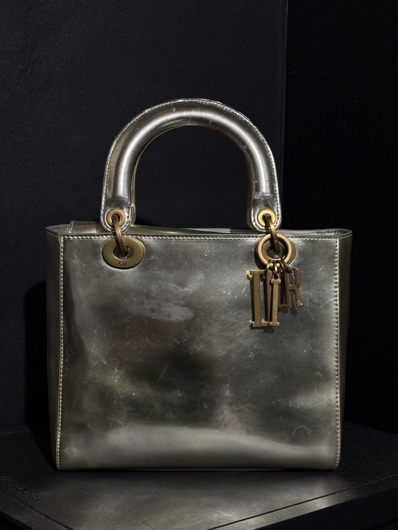 RARE CHRISTIAN DIOR LADY DIOR METALLIC SILVER (Category: Luxury Bags & Wallets) located in Quezon City. Submitted by qr8d.ph (Listing ID 1470201788, Image 1). Description: ❗️PLEASE READ❗️ This is a heavily used lady dior in metallic silver exterior with brass gold hardware Item comes with a non adjustable but removable strap in the same material of the bag FLAW/s: Material of the bag is of some sort of a laminated finish so some parts of the lami