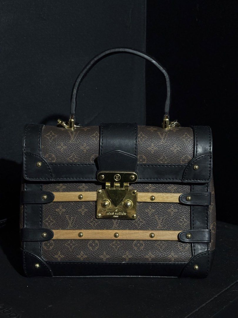 RARE LOUIS VUITTON TRIANON PM (Category: Luxury Bags & Wallets) located in Quezon City. Submitted by qr8d.ph (Listing ID 1470211279, Image 1). Description: ❗️PLEASE READ❗️ Item is a rare Louis Vuitton Trianon PM bag in classic monogram coated leather with black leather lining and gold hardware, it comes with a wooden accent on both front and back of the bag that gives it the classic trunk vibes where LV is very known for. Item comes with an adjus