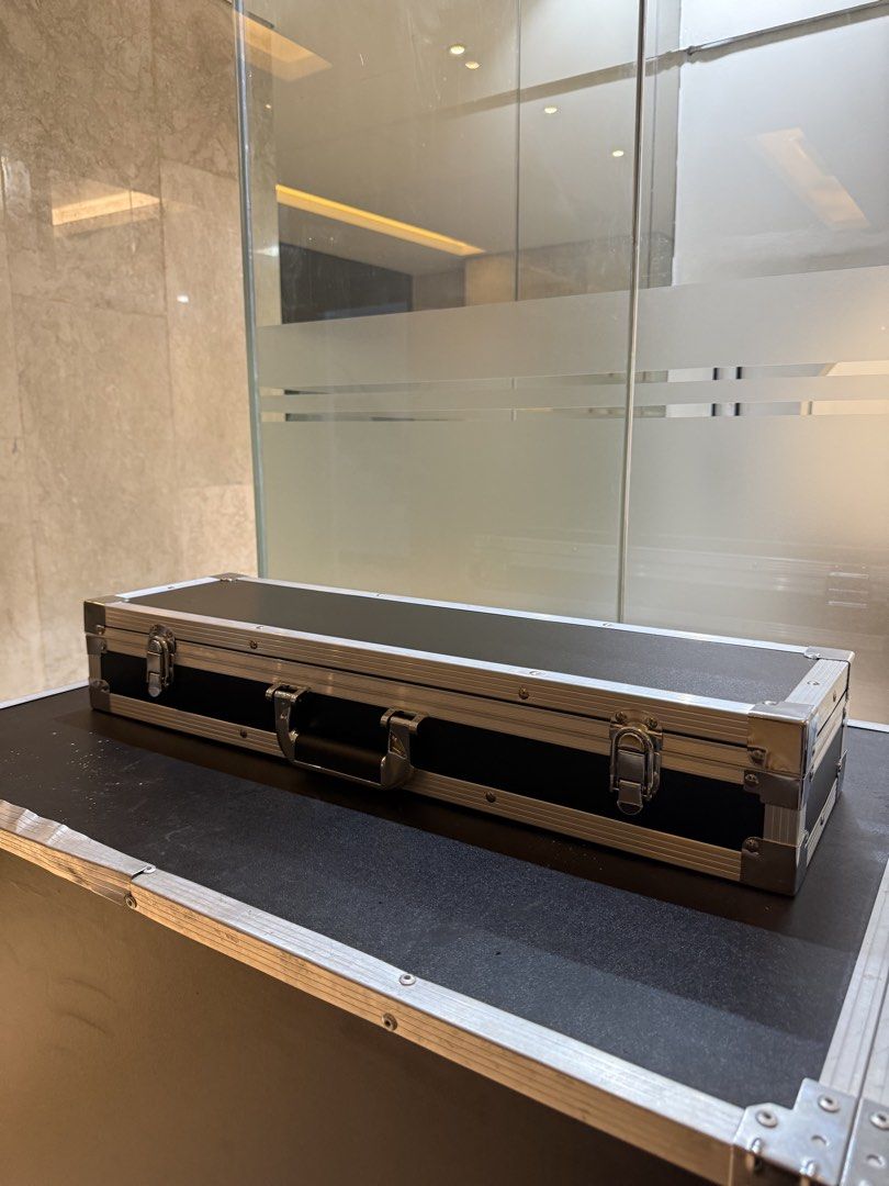Rectangular Flight Case (Category: Luggage) located in Rodriguez. Submitted by kewpiee.ie403 (Listing ID 1470328860, Image 2). Description: Selling a black, hard-shell equipment flight case with aluminum edging, heavy-duty metal latches, and a built-in handle. Comes with custom-cut foam inserts designed to securely hold and protect specific equipment during storage and transport. Features: * Durable hard-shell construction * Black exterior with a