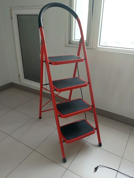 Red 4-Step Folding Ladder with Handgrip (Category: Ladders & Steps) located in Quezon City. Submitted by susmaryosep1 (Listing ID 1470260259, Image 1). Description: Bright red 4-step folding ladder. Sturdy metal frame with black non-slip treads on every step. Curved top handle features a comfortable foam grip for extra stability while climbing. Cross-brace structure on the back keeps it firmly locked in place. Folds flat easily for storage in clo