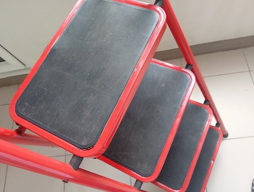 Red 4-Step Folding Ladder with Handgrip (Category: Ladders & Steps) located in Quezon City. Submitted by susmaryosep1 (Listing ID 1470260259, Image 2). Description: Bright red 4-step folding ladder. Sturdy metal frame with black non-slip treads on every step. Curved top handle features a comfortable foam grip for extra stability while climbing. Cross-brace structure on the back keeps it firmly locked in place. Folds flat easily for storage in clo