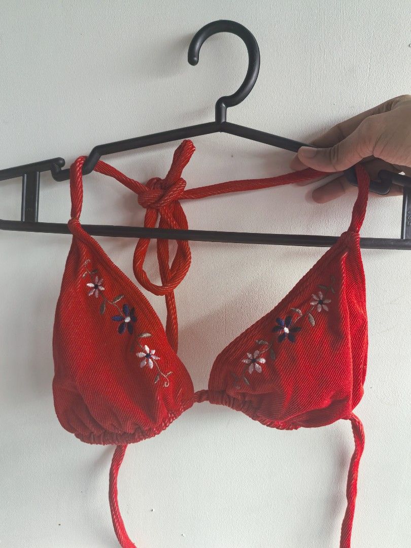 Red Embroidered Halter Bikini Top (Category: Bikinis & Swimsuits) located in Taguig. Submitted by iggysclutter (Listing ID 1470250277, Image 1). Description: - Color: Bright red - Material: Ribbed textured fabric - Design: Embroidered daisy flowers along the straps - Closure: Adjustable ties at the neck and back - Occasion: Ideal for the beach or pool parties.