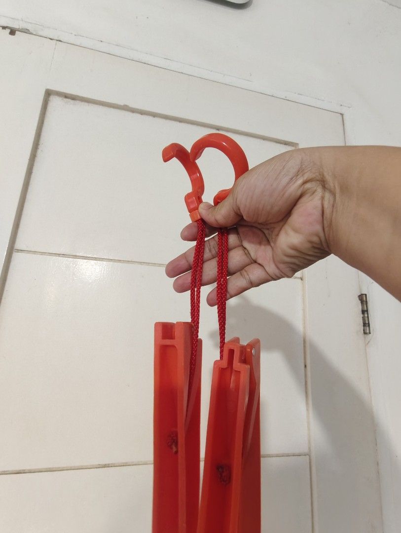 Red Foldable Multiple Clothes Hanger (Category: Hooks & Hangers) located in Bulacan. Submitted by babz30261 (Listing ID 1470262214, Image 2). Description: - Bright red collapsible clothes hanger for space-saving vertical storage - Folds up compactly, perfect for travel and easy storage twooo - Features sturdy hooks and red string cords - Made from durable, vibrant red plastic.