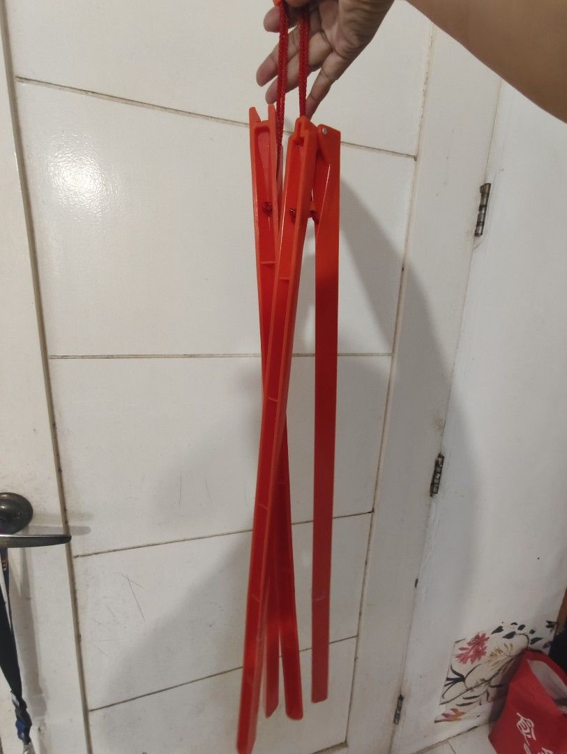 Red Foldable Multiple Clothes Hanger (Category: Hooks & Hangers) located in Bulacan. Submitted by babz30261 (Listing ID 1470262214, Image 3). Description: - Bright red collapsible clothes hanger for space-saving vertical storage - Folds up compactly, perfect for travel and easy storage twooo - Features sturdy hooks and red string cords - Made from durable, vibrant red plastic.