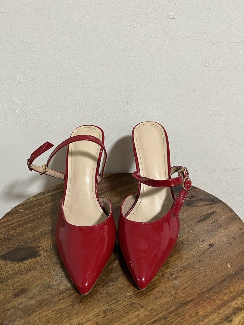 Red Patent Slingback Stiletto Heels (Category: Heels) located in Cabuyao City. Submitted by rdtrmt (Listing ID 1470179458, Image 3). Description: - Style: Bright red patent leather slingback heels with pointed toe and slim stiletto heel - Size: EUR 38 - Details: Adjustable buckle strap across the midfoot - Condition: Clean leather and heels, soles show light signs of wear - Perfect for: Parties, clubbing, and making a bold fashion statement.