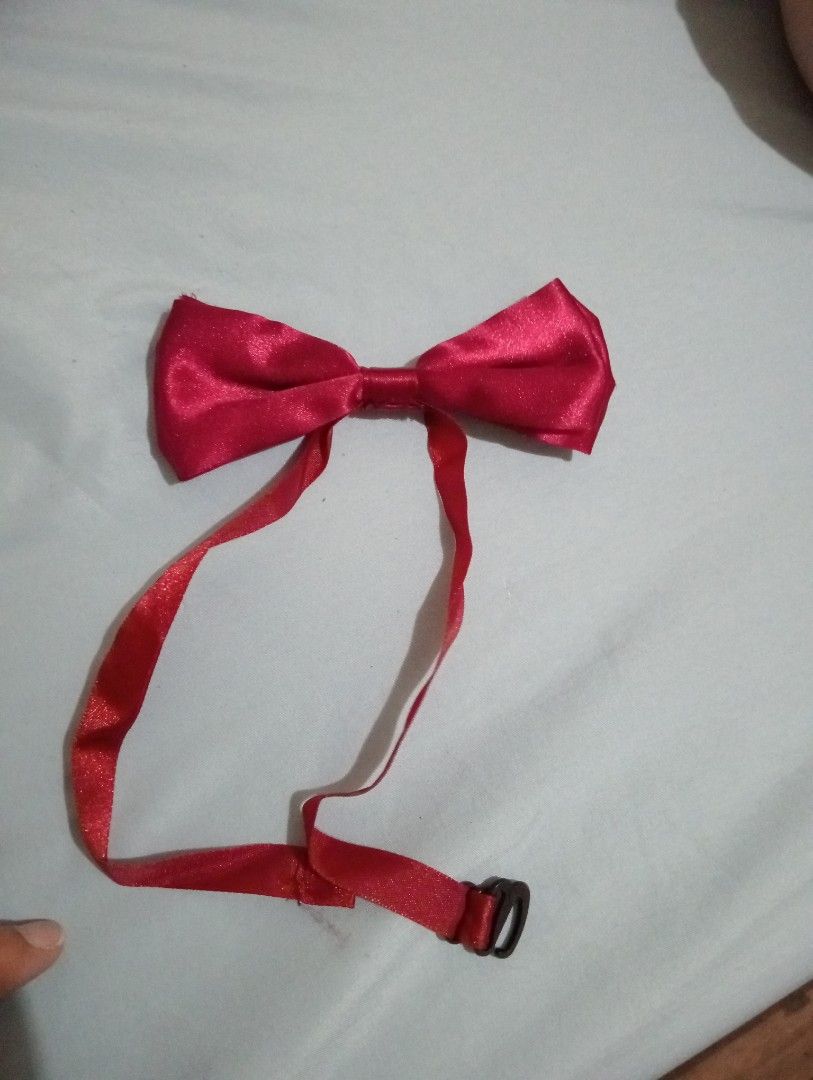 Red Satin Bow Tie with Adjustable Strap (Category: Ties) located in Makati City. Submitted by YSL80022 (Listing ID 1470160754, Image 1). Description: - Color: Bright red - Material: Glossy satin - Closure: Adjustable neck strap with black plastic clasp and hook - Occasion: Ideal for weddings, parties, and formal events.