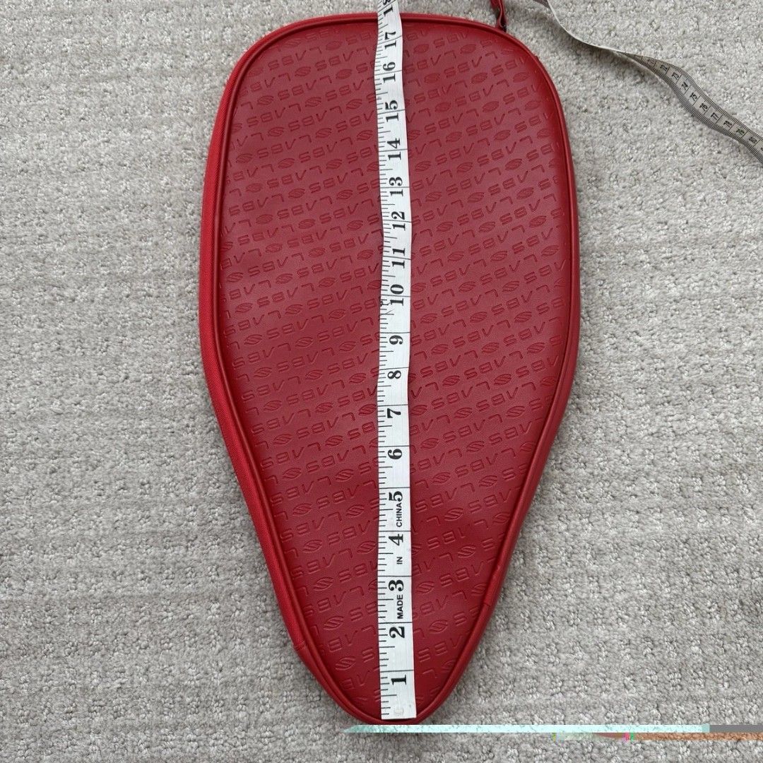 Red selkirk SLABS paddle Cover Bag (Category: Racket and Ball Sports) located in Batangas. Submitted by curatedluxxe88 (Listing ID 1470153569, Image 2). Description: - Brand: Selkirk - Color: Red with all-over debossed logo pattern - Closure: Smooth side zipper - Dimensions: Approx. 18 inches long x 11 inches wide - Condition: Clean shape, fully functional zipper - Ideal for storing and protecting your pickleball gear.
