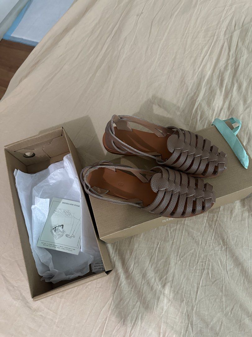 Renegade Folk Woven Leather Sandals (Category: Flats & Sandals) located in Quezon City. Submitted by kittytangco (Listing ID 1470347995, Image 3). Description: - Brand: Renegade Folk - Style: Woven leather strap flat sandals with open back and ankle strap - Color: Versatile taupe brown - Condition: Brand new, never worn out, pristine condition - Comfort: Features a soft, cushioned footbed for all-day wear - Inclusions: Comes with original branded