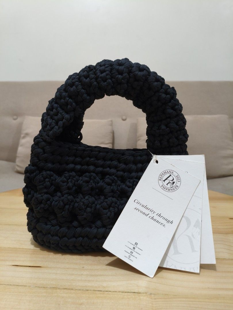 REPAMANA Pypupa Crocheted Handbag Black (Category: Shoulder Bags) located in Quezon City. Submitted by petie_ph (Listing ID 1470147940, Image 1). Description: - New, never used - Original price is Php 1,500.00 - Brand: Repamana Pypupa - Color: Black - Design: Crocheted with a thick rounded handle - Condition: Brand new with original tags still attached - Sustainability: Made from repurposed knitted shirts by female prisoners in Quezon City, suppo