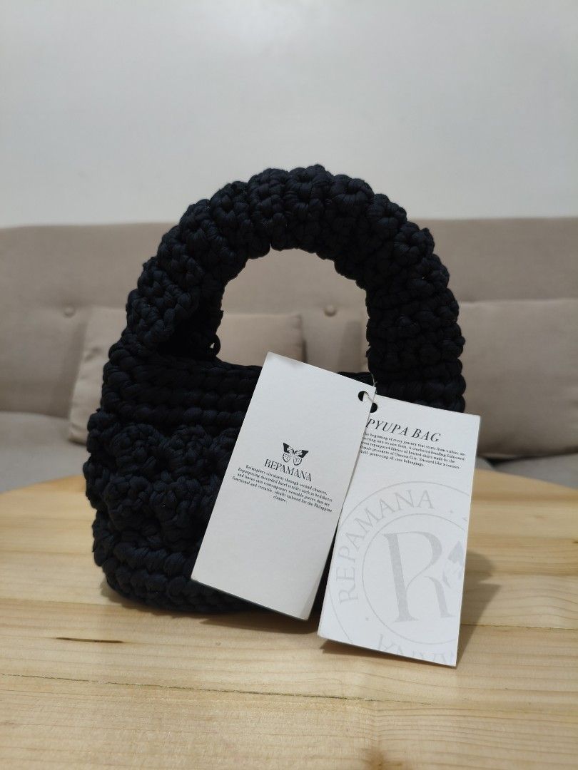 REPAMANA Pypupa Crocheted Handbag Black (Category: Shoulder Bags) located in Quezon City. Submitted by petie_ph (Listing ID 1470147940, Image 3). Description: - New, never used - Original price is Php 1,500.00 - Brand: Repamana Pypupa - Color: Black - Design: Crocheted with a thick rounded handle - Condition: Brand new with original tags still attached - Sustainability: Made from repurposed knitted shirts by female prisoners in Quezon City, suppo