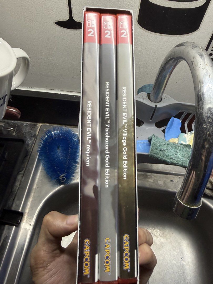 Resident Evil Generation Pack Nintendo Switch 2 (Category: Nintendo) located in Del Monte. Submitted by fransconst (Listing ID 1470192273, Image 3). Description: - Platform: Nintendo Switch 2 (Game-key card format inside box) - Includes 3 massive titles: Resident Evil 7 biohazard Gold Edition, Resident Evil Village Gold Edition, and Resident Evil Requiem - Exclusive 30th Anniversary Edition packaging featuring premium gold foil details and the ic