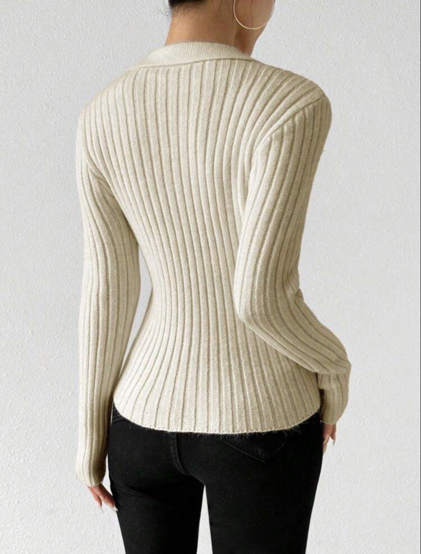 Ribbed Collared Long Sleeve Knit Top (Category: Longsleeves) located in Manila. Submitted by angelyelsha (Listing ID 1470154848, Image 2). Description: - Color: Cream/Khaki - Style: Fitted ribbed knit with pointed collar and V-neck - Details: Long sleeves with flared cuffs, small embroidered logo on chest - Material: Soft, fuzzy, and stretchy fabric - Condition: Excellent - Perfect for effortless layering or chic solo wear.