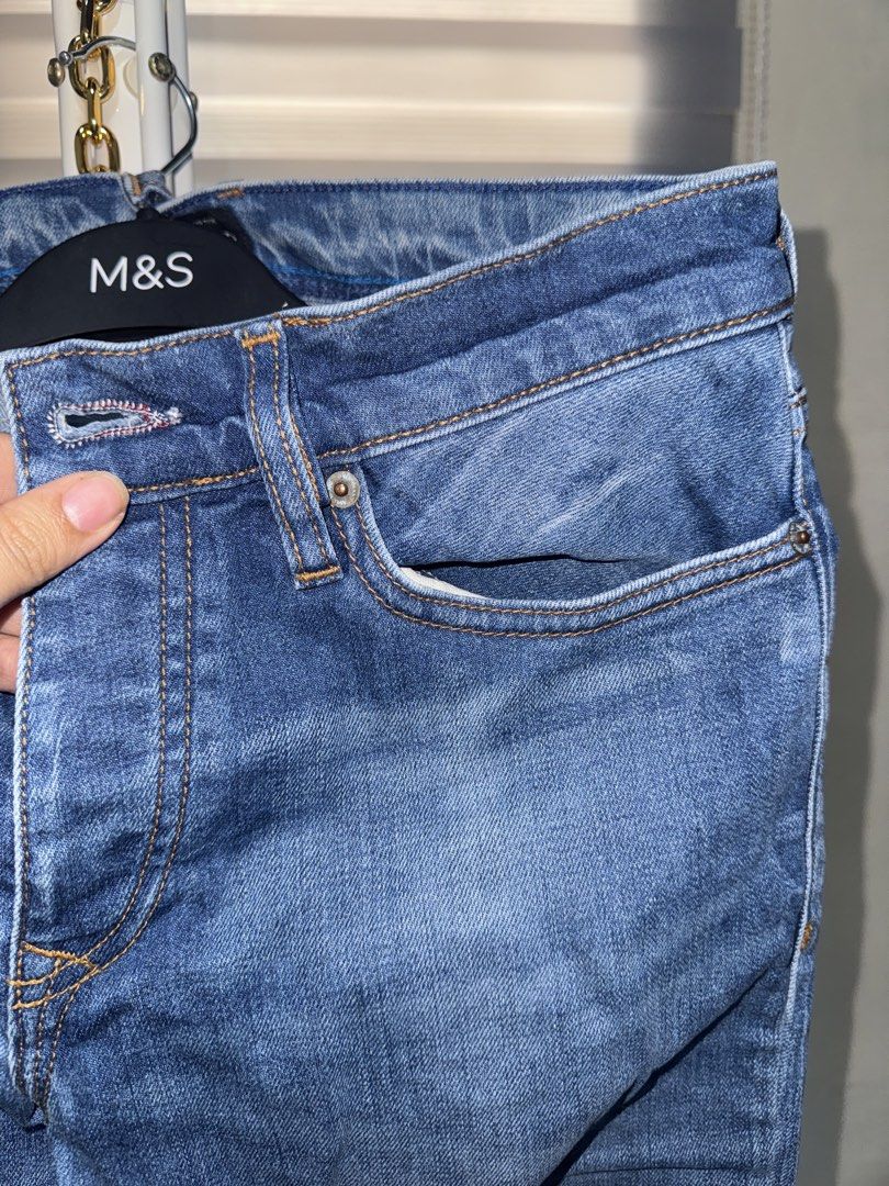 River Island Blue Denim Jeans (Category: Jeans) located in La Trinidad. Submitted by prelovedandfindsbyji (Listing ID 1470235619, Image 3). Description: - Brand: River Island - Color/Wash: Blue, medium wash - Fit: Straight leg - Closure: Button fly with branded metal buttons - Pockets: Classic five-pocket design plus a coin pocket - Details: Leather patch on the back waistband - Condition: Good staple piece for everyday outfits.