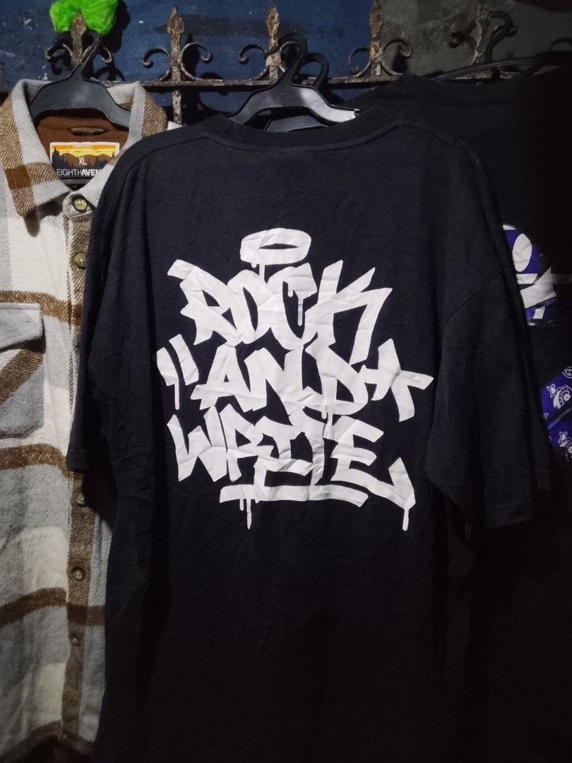 Rock And Write Black Graphic T-Shirt (Category: Tshirts & Polo Shirts ) located in Manila. Submitted by warmcloud-06f3 (Listing ID 1470216901, Image 2). Description: - Brand: Rock And Write (Est. 2018) - Color: Classic Black - Design: Small graffiti hand can print on the chest with a large graffiti text logo across the back - Details: Ribbed crew neck collar and authentic brand neck label inside - Condition: Brand new / Excellent quality - Perfec