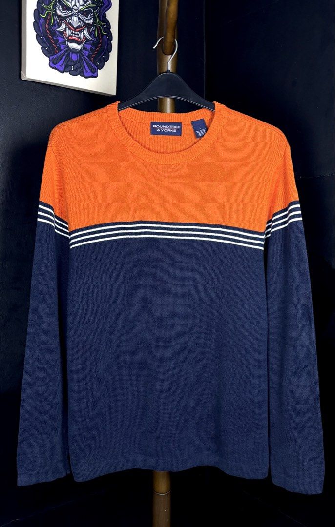 Roundtree & Yorke Colorblock Crewneck Sweater (Category: Coats, Jackets and Outerwear) located in Bacoor. Submitted by calvinmanzano13 (Listing ID 1470196452, Image 1). Description: - L = 27.5” | W = 22” - Color: Orange and navy blue - Design: Striped chevron detail across chest and sleeves - Details: Long sleeves, ribbed crew neckline - Material: 55% acrylic, 45% cotton - Origin: Made in Hong Kong Notes: 🔥 Hand washed 🔥 Polished 🔥 Steam irone