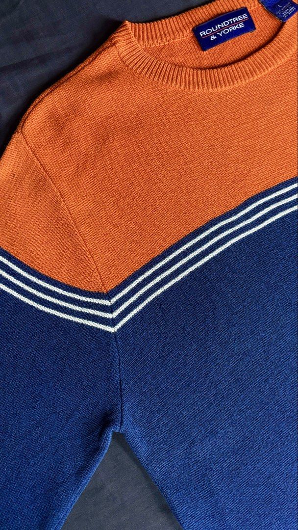 Roundtree & Yorke Colorblock Crewneck Sweater (Category: Coats, Jackets and Outerwear) located in Bacoor. Submitted by calvinmanzano13 (Listing ID 1470196452, Image 3). Description: - L = 27.5” | W = 22” - Color: Orange and navy blue - Design: Striped chevron detail across chest and sleeves - Details: Long sleeves, ribbed crew neckline - Material: 55% acrylic, 45% cotton - Origin: Made in Hong Kong Notes: 🔥 Hand washed 🔥 Polished 🔥 Steam irone