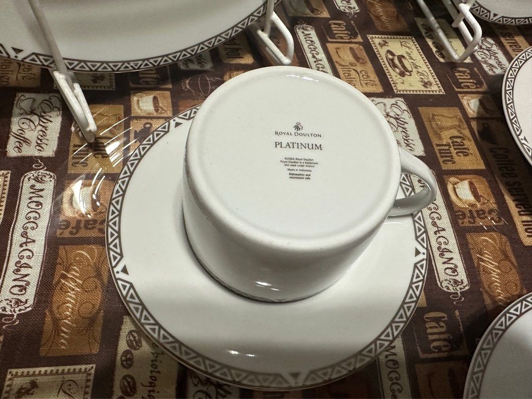 Royal Doulton Platinum Dinnerware Set Cups Saucers Plates (Category: Dinnerware & Cutlery) located in Mandaue City. Submitted by erin_grace (Listing ID 1470167607, Image 2). Description: - Brand/Pattern: Royal Doulton Platinum (© 2004, made in Indonesia) - Material: Premium white porcelain - Design: Modern geometric grey and silver rims - Set Includes: Large plates, medium plates, cups, and matching saucers - Care: Dishwasher and microwave safe -