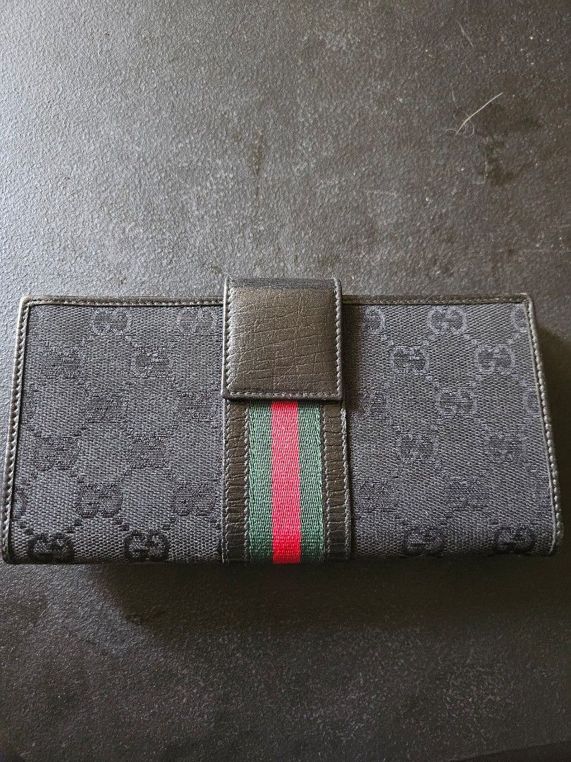 RUSH! Gucci Monogram Continental Flap Long Wallet (Category: Luxury Bags & Wallets) located in Pasig City. Submitted by allstarkenny25 (Listing ID 1470204235, Image 2). Description: - Brand: Gucci - Style: Long wallet - Material: Black monogram canvas and textured leather - Design: Iconic red and green web stripe with gold-tone hardware clasp - Interior: Multiple card slots and spacious cash compartments with stamped Gucci logo - Condition: Class