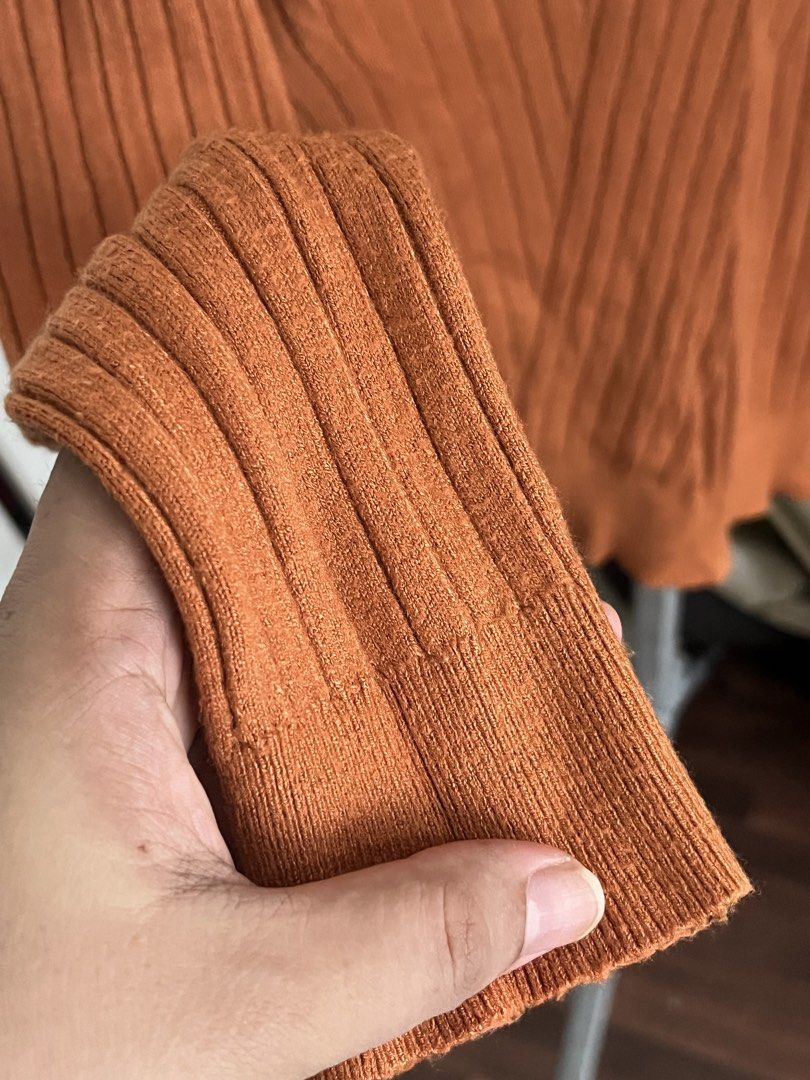 Rust Orange Ribbed Knit Sweater with Ruffled Mock Neck (Category: Coats, Jackets and Outerwear) located in Manila. Submitted by loveemjmaria (Listing ID 1470194843, Image 3). Description: Ribbed knit sweater in rich rust orange. Mock neckline featuring contrasting light beige ruffled trim. Long sleeves with vertical ribbing throughout the body. Stretchy fabric, great layering piece for cooler weather. Clean knit texture on cuffs and hem. RFS: Doe