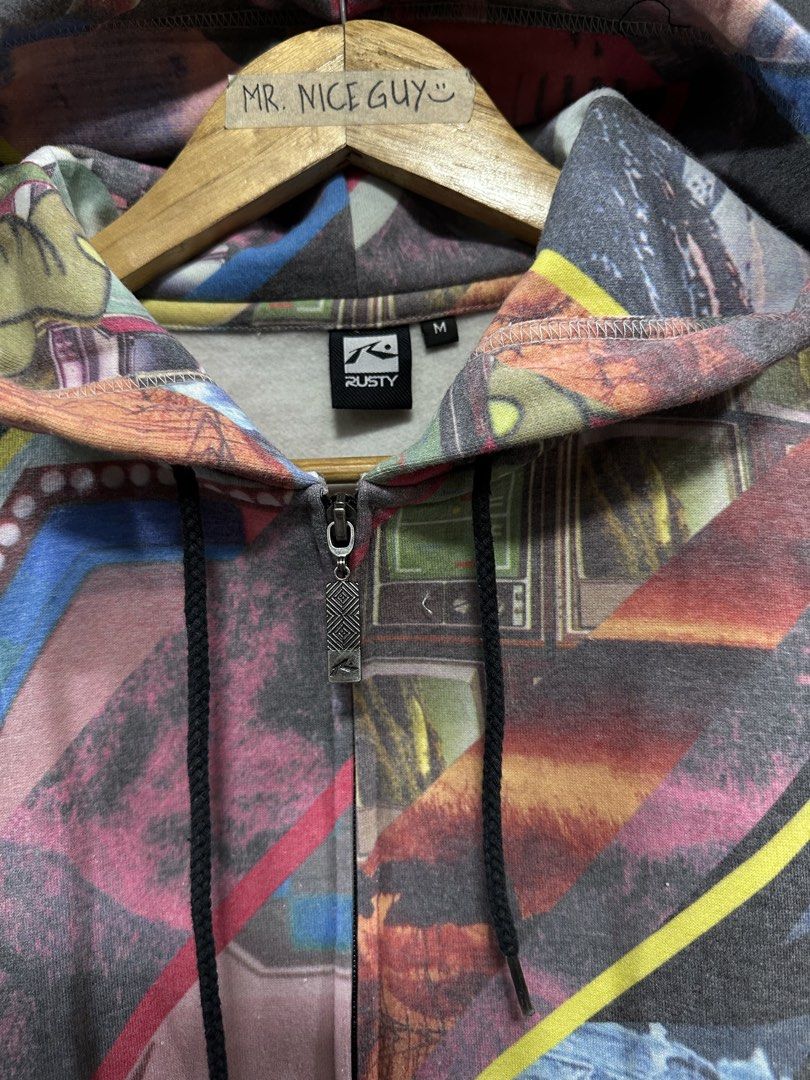Rusty Full Zip Graphic Print Hoodie Size M (Category: Coats, Jackets and Outerwear) located in Mabalacat. Submitted by mrniceguy421 (Listing ID 1470173599, Image 3). Description: - Brand: Rusty - Style: Full-zip hoodie with an all-over abstract collage print - Size: Medium (tag on collar) - Details: Black ribbed cuffs and hem, adjustable hood drawstrings, branded zipper pull - Vibe: Colorful streetwear piece - Condition: Well-maintained and ready