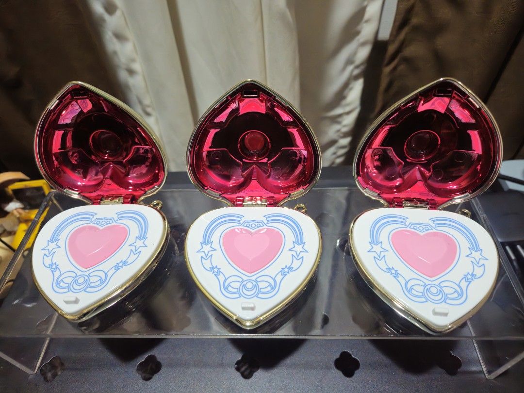 Sailor Moon Cosmic Heart Compact Mirror (Category: Mirrors) located in Binan City. Submitted by davyltnh (Listing ID 1470336655, Image 2). Description: - Sailor Moon Cosmic Heart compact cases - Gorgeous gold metallic finish with red crystal details on top - Interior features a pink heart shape with white lid detailing, blue bows, and stars - Includes official Sailor Moon logo and copyright text on the backside - Brand new and ready for your coll