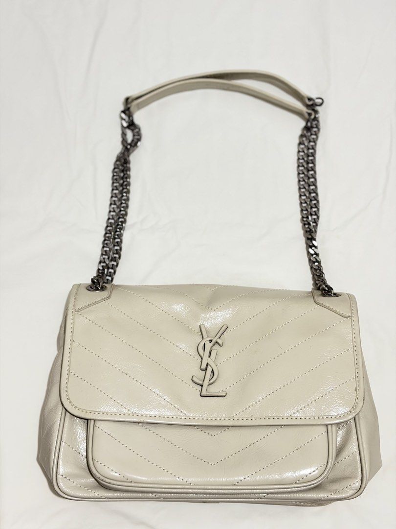 Saint Laurent College Monogram Chain Bag (Category: Luxury Bags & Wallets) located in Mabalacat. Submitted by davidbianc04942 (Listing ID 1470297235, Image 1). Description: - Style: Light grey leather shoulder bag with chic chevron quilting - Hardware: Edgy gunmetal hardware with signature front YSL monogram - Straps: Double chain straps equipped with comfortable leather shoulder pads - Closure: Secure magnetic snap closure on both the main flap 