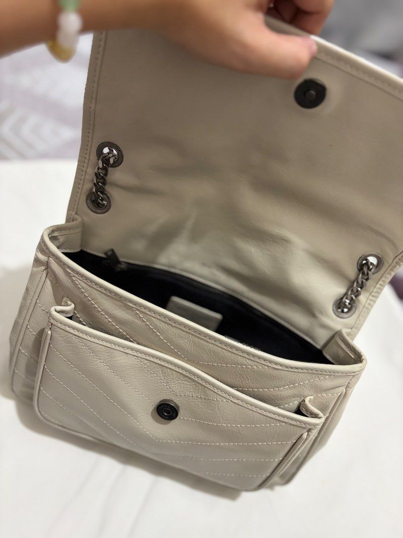 Saint Laurent College Monogram Chain Bag (Category: Luxury Bags & Wallets) located in Mabalacat. Submitted by davidbianc04942 (Listing ID 1470297235, Image 2). Description: - Style: Light grey leather shoulder bag with chic chevron quilting - Hardware: Edgy gunmetal hardware with signature front YSL monogram - Straps: Double chain straps equipped with comfortable leather shoulder pads - Closure: Secure magnetic snap closure on both the main flap 