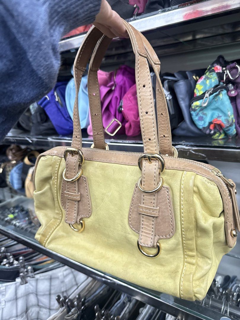 Salad Yellow Leather Handbag (Category: Luxury Bags & Wallets) located in Abucay. Submitted by fastlion.584bdf (Listing ID 1470268658, Image 3). Description: - Brand: Salad - Material: Yellow leather with tan leather handles and trim - Hardware: Gold-tone throughout - Closure: Secure zip top - Extras: Original 'I Love Salad' hanging tag and brand charm included - Design: Compact size with sturdy double handles and front buckle accents.