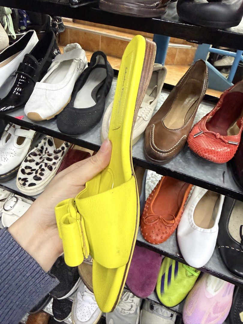 Salvatore Ferragamo Yellow Sandals (Category: Flats & Sandals) located in Abucay. Submitted by fastlion.584bdf (Listing ID 1470270941, Image 3). Description: - Brand: Salvatore Ferragamo - Style: Slip-on flat slide sandals - Color: Vibrant bright yellow with matching bow accent - Size: US 9 (stamped on sole) - Material: Clean leather upper - Condition: Soles show minor wear from walking, overall upper is in great shape.