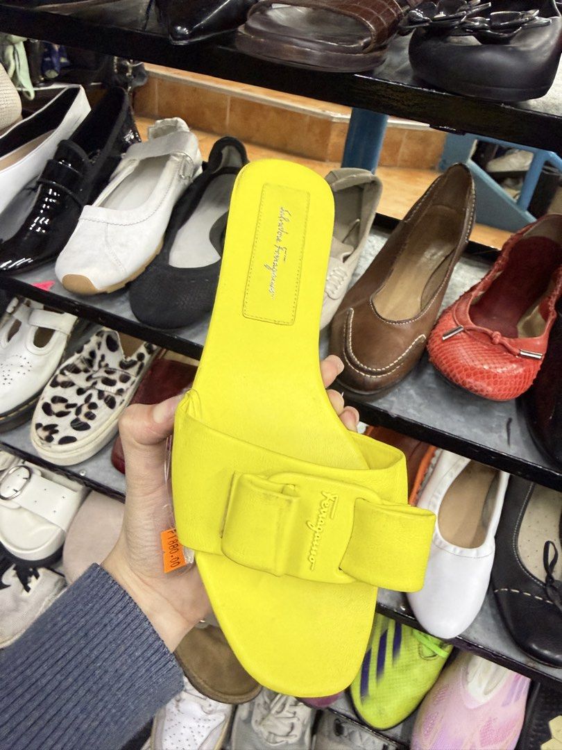 Salvatore Ferragamo Yellow Sandals (Category: Flats & Sandals) located in Abucay. Submitted by fastlion.584bdf (Listing ID 1470270941, Image 2). Description: - Brand: Salvatore Ferragamo - Style: Slip-on flat slide sandals - Color: Vibrant bright yellow with matching bow accent - Size: US 9 (stamped on sole) - Material: Clean leather upper - Condition: Soles show minor wear from walking, overall upper is in great shape.