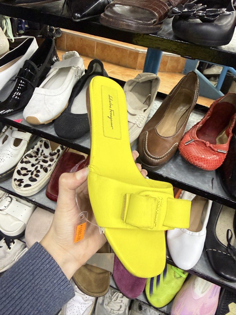 Salvatore Ferragamo Yellow Sandals (Category: Flats & Sandals) located in Abucay. Submitted by fastlion.584bdf (Listing ID 1470270941, Image 1). Description: - Brand: Salvatore Ferragamo - Style: Slip-on flat slide sandals - Color: Vibrant bright yellow with matching bow accent - Size: US 9 (stamped on sole) - Material: Clean leather upper - Condition: Soles show minor wear from walking, overall upper is in great shape.