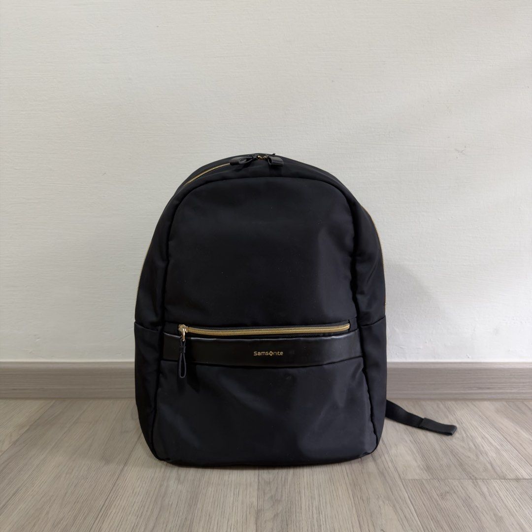 Samsonite Backpack (Category: Backpacks) located in Singapore. Submitted by carousae (Listing ID 1470236243, Image 1). Description: - Color: Classic black with elegant gold hardware zippers - Dimensions: 290 mm (W) x 400 mm (H) x 160 mm (D) - Features: Spacious main compartment, front zip pocket, adjustable shoulder straps, and top grab handle - Good condition with minimal wear - Free tracked mail.