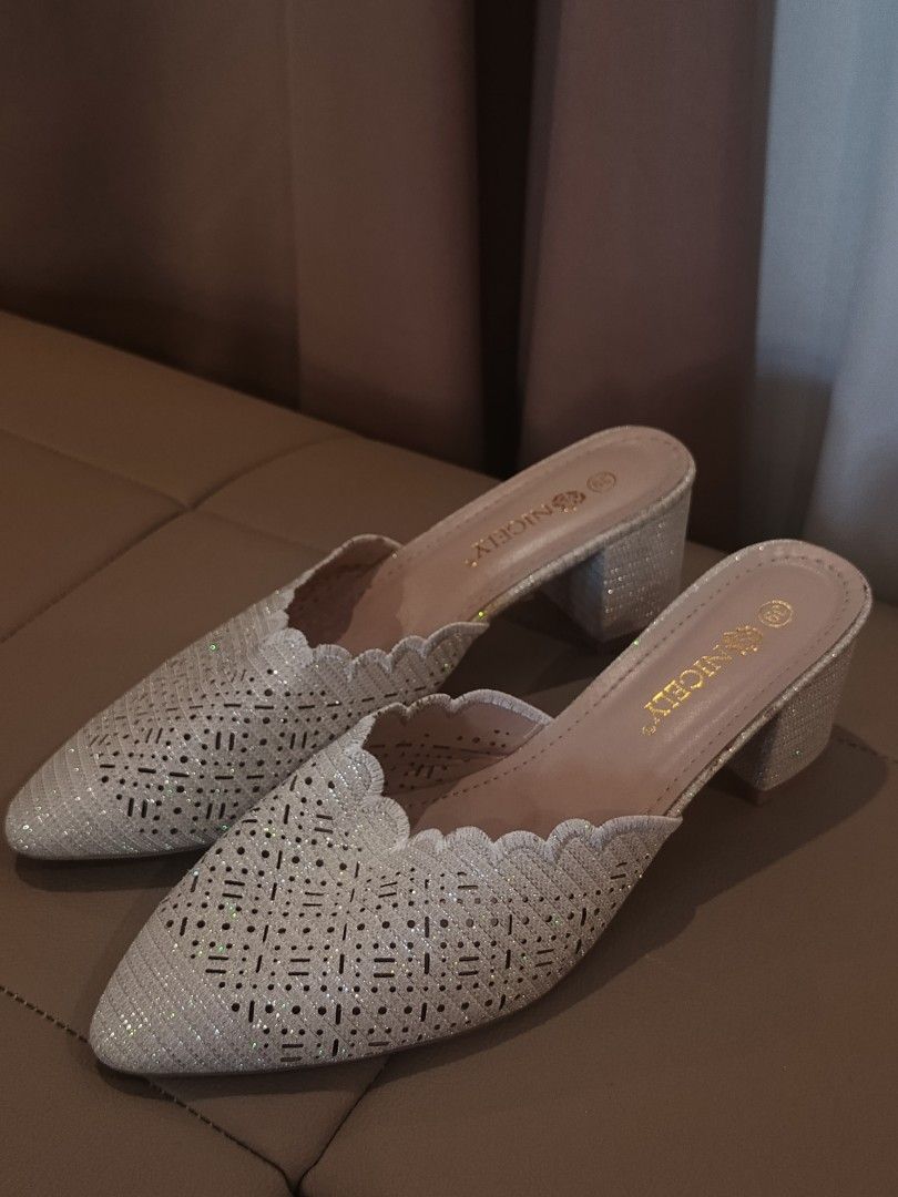 Sandals Set Bought in Dubai (Category: Heels) located in Arayat. Submitted by akahana_ (Listing ID 1470225341, Image 3). Description: - Pointed closed-toe mules with easy slip-on design - Color/Finish: Stunning silver glitter - Details: Laser-cut geometric patterns and scalloped edge trim - Heel: Comfortable chunky block heel - Size: 39 (stamped on insole) - Inclusions: Original box included - Bonus: Matching criss-cross heels also available (see