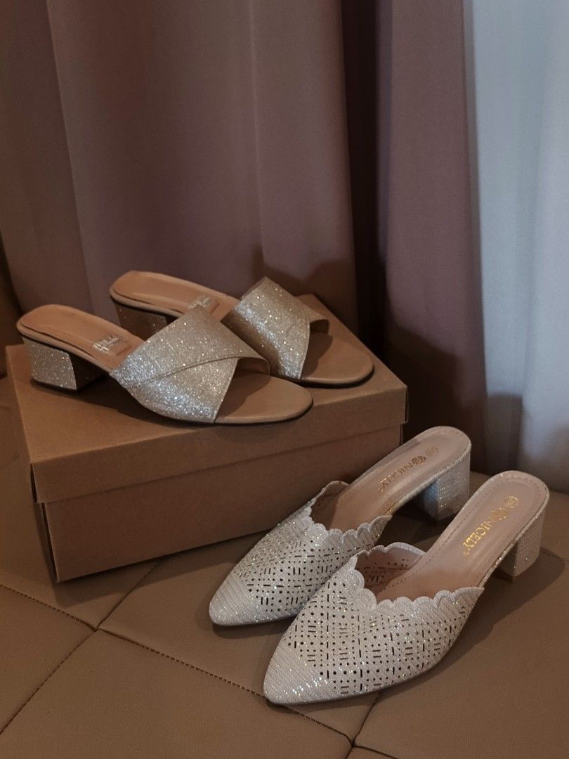 Sandals Set Bought in Dubai (Category: Heels) located in Arayat. Submitted by akahana_ (Listing ID 1470225341, Image 1). Description: - Pointed closed-toe mules with easy slip-on design - Color/Finish: Stunning silver glitter - Details: Laser-cut geometric patterns and scalloped edge trim - Heel: Comfortable chunky block heel - Size: 39 (stamped on insole) - Inclusions: Original box included - Bonus: Matching criss-cross heels also available (see