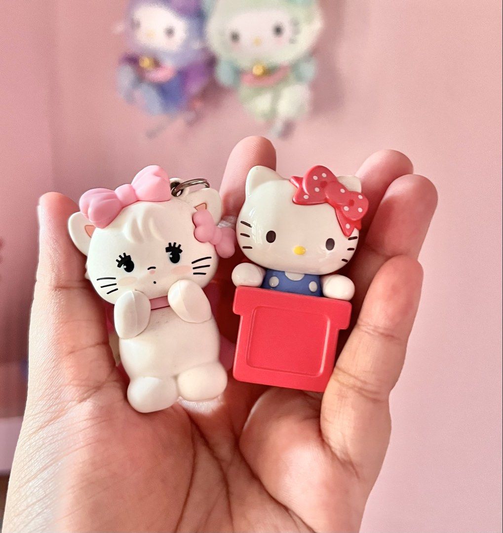 Sanrio Hello Kitty and Mikko Illustration Keychains (Category: Character Goods) located in Imus. Submitted by muyingyingyinggg (Listing ID 1470237744, Image 1). Description: - Set of 2 cute collectible keychains: Sanrio Kitty and Mikko Illustration white cat with a pink bow - Authentic items with visible copyright marks on the back - Perfect accessories to style your bags, purses, or keys - Compact size, easy to carry and show off.