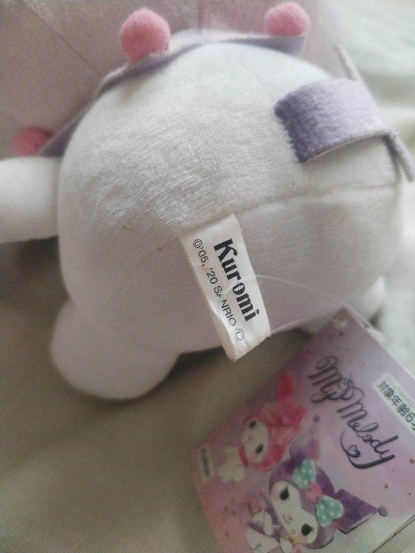 Sanrio Kuromi Plush Toy (Category: Plushies & Soft Toys) located in Davao. Submitted by belles_pre_loved (Listing ID 1470157587, Image 3). Description: - Authentic FuRyu Sanrio Kuromi plush toy - Rare light purple and white color scheme with a cute blue ribbon - Sitting pose, made with ultra-soft fabric - Features original paper tag with My Melody and Kuromi artwork - Tush tag intact, dated Sanrio 2005, 2020.