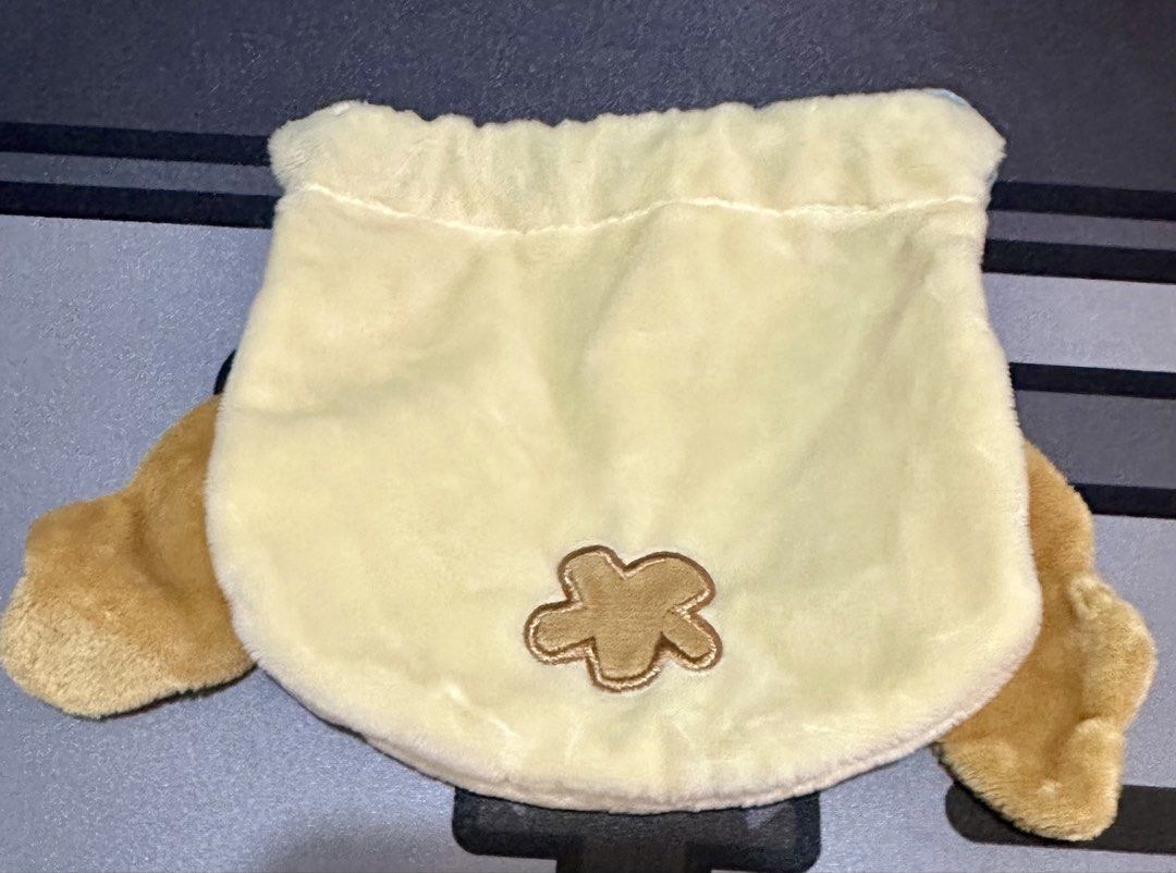 Sanrio Plush Chiffon Drawstring Pouch (Category: Plushies & Soft Toys) located in Manila. Submitted by lunalux09 (Listing ID 1470178448, Image 2). Description: - Official Sanrio merchandise with interior copyright tag - Adorable yellow plush design featuring Pompompurin's face - Cute brown flower detail on the back - Secure blue rope drawstring closure - Soft and fuzzy texture - Compact size, ideal for makeup, trinkets, or daily accessories - Exc