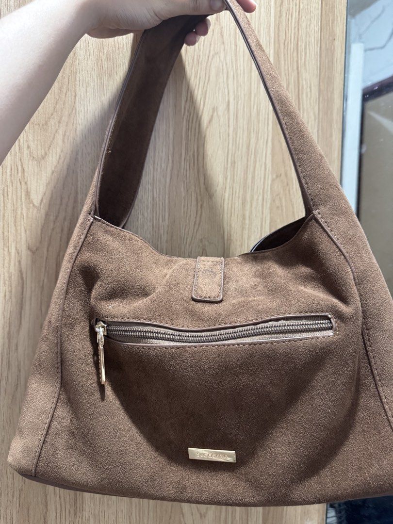 Secosana ALBA Suede Shoulder Bag (Category: Shoulder Bags) located in Lipa City. Submitted by kelayaaa (Listing ID 1470259668, Image 2). Description: - Brand/Model: Secosana ALBA Suede Shoulder Bag - Hardware: Elegant gold-tone accents - Design: Front buckle detail and secure zippered back pocket - Dimensions: 32.5 cm (W) x 20 cm (H) x 10 cm (D) - Strap Drop: 21 cm - Weight: Lightweight at 0.3 kg Used but not abused. .
