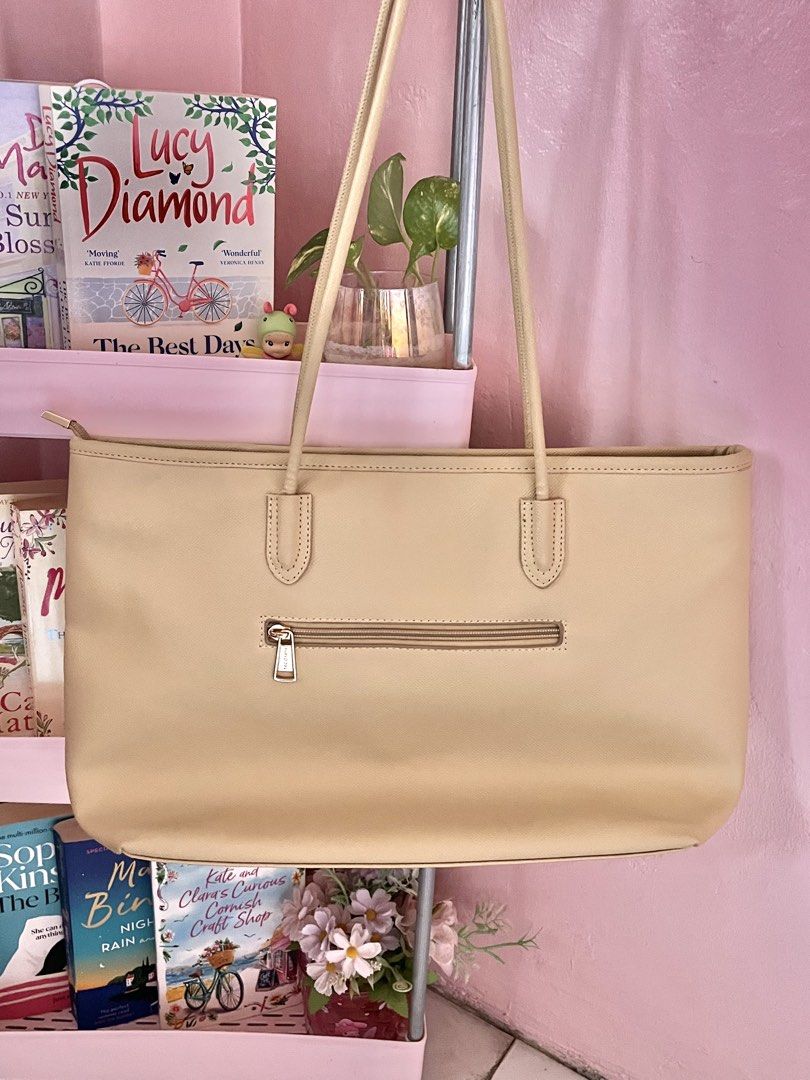 Secosana Beige Tote Bag (Category: Tote Bags) located in Imus. Submitted by muyingyingyinggg (Listing ID 1470237273, Image 2). Description: - Brand: Secosana - Color: Classic beige (neutral shade) - Design: Structured shape with gold-tone hardware and clean texture - Pockets: Front slip pocket, exterior back zip pocket, plus interior slip pockets and a zippered compartment - Closure & Carry: Top zip closure with comfortable shoulder straps.