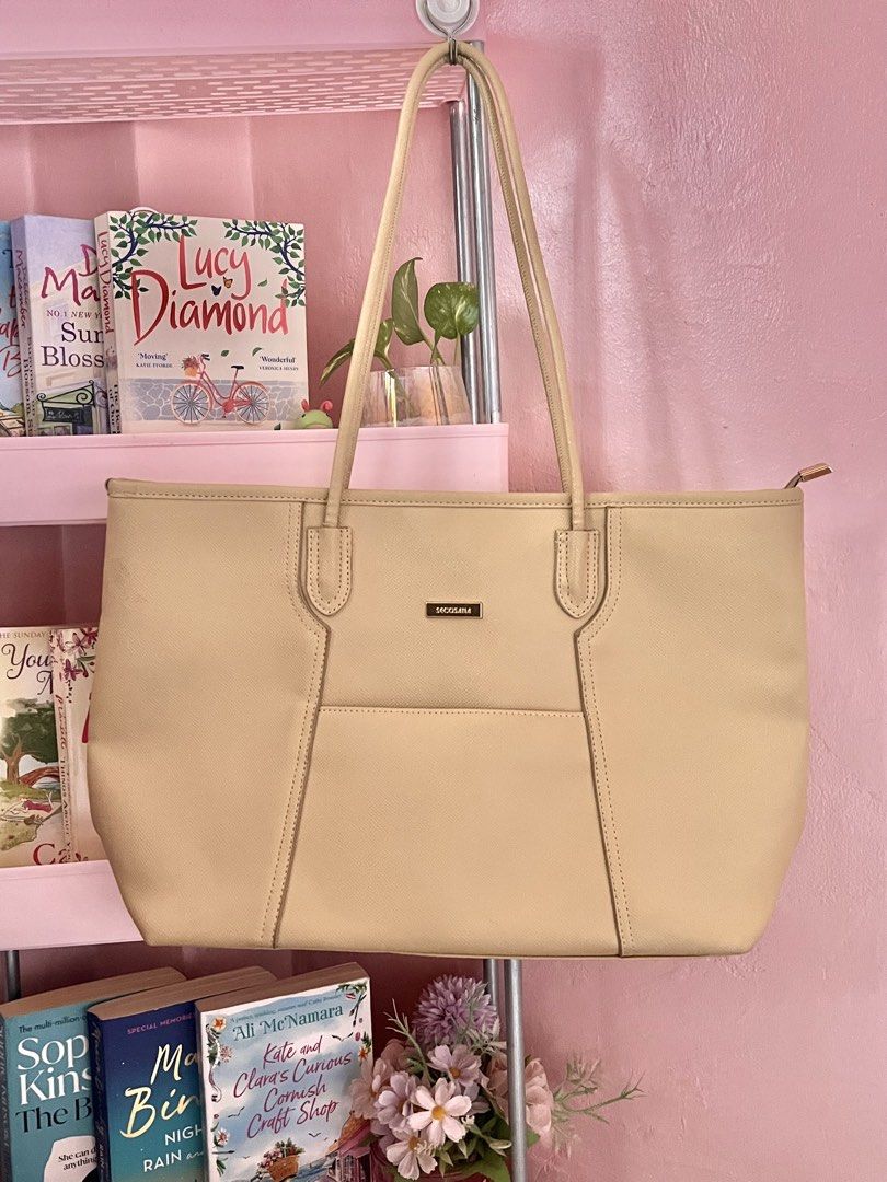 Secosana Beige Tote Bag (Category: Tote Bags) located in Imus. Submitted by muyingyingyinggg (Listing ID 1470237273, Image 1). Description: - Brand: Secosana - Color: Classic beige (neutral shade) - Design: Structured shape with gold-tone hardware and clean texture - Pockets: Front slip pocket, exterior back zip pocket, plus interior slip pockets and a zippered compartment - Closure & Carry: Top zip closure with comfortable shoulder straps.