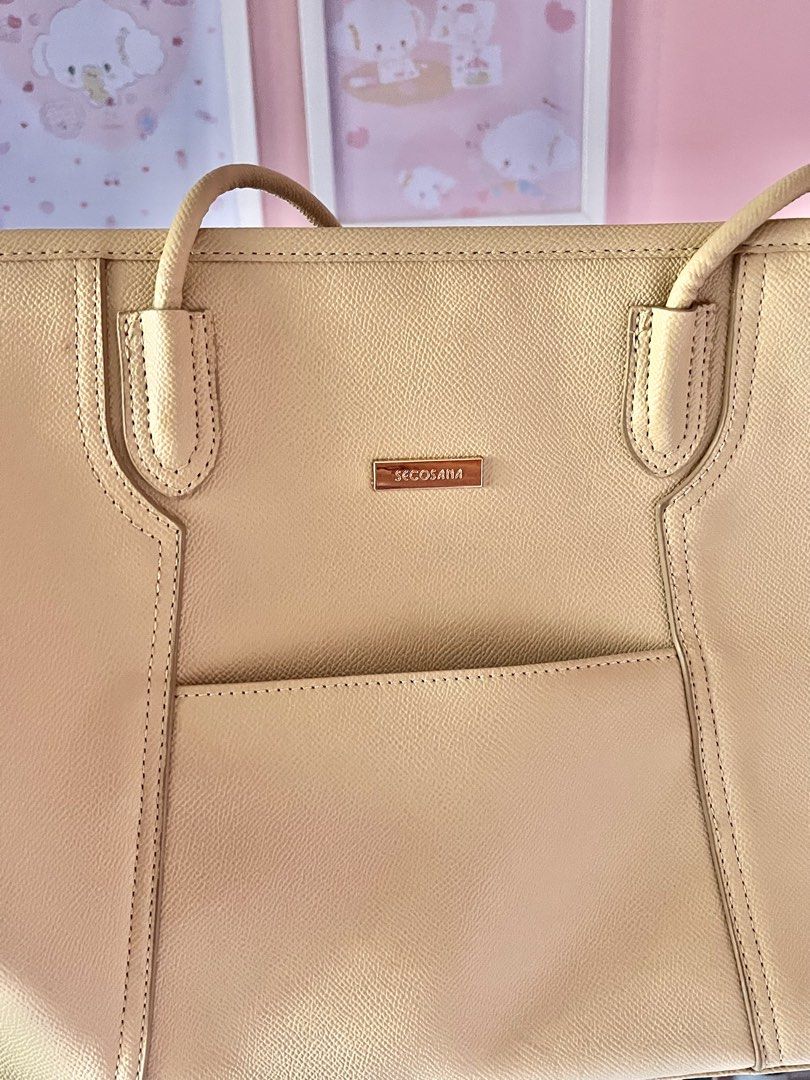 Secosana Beige Tote Bag (Category: Tote Bags) located in Imus. Submitted by muyingyingyinggg (Listing ID 1470237273, Image 3). Description: - Brand: Secosana - Color: Classic beige (neutral shade) - Design: Structured shape with gold-tone hardware and clean texture - Pockets: Front slip pocket, exterior back zip pocket, plus interior slip pockets and a zippered compartment - Closure & Carry: Top zip closure with comfortable shoulder straps.