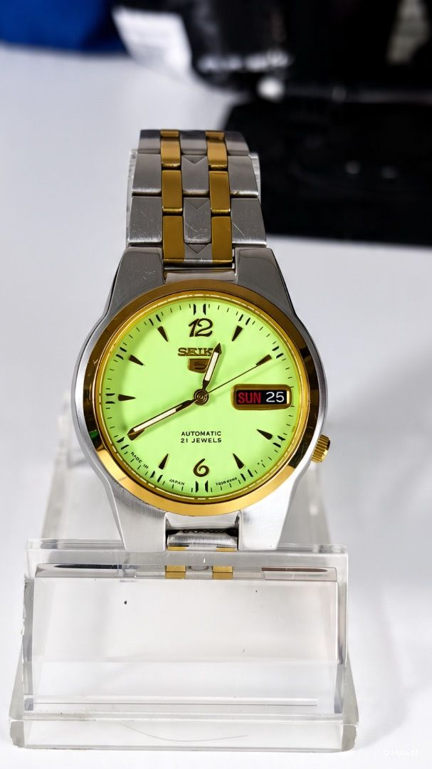Seiko 5 Automatic 21 Jewels Two-Tone Watch (Category: Men's Watches) located in Caloocan City. Submitted by imlei (Listing ID 1470301818, Image 1). Description: - Brand/Model: Seiko 5 Automatic Watch - Movement: Reliable 21 jewels automatic movement with visible exhibition case back - Dial: Striking bright yellow-green dial with prominent 6 and 12 numerals - Features: Convenient day and date display at the 3 o'clock position - Design: Two-tone st