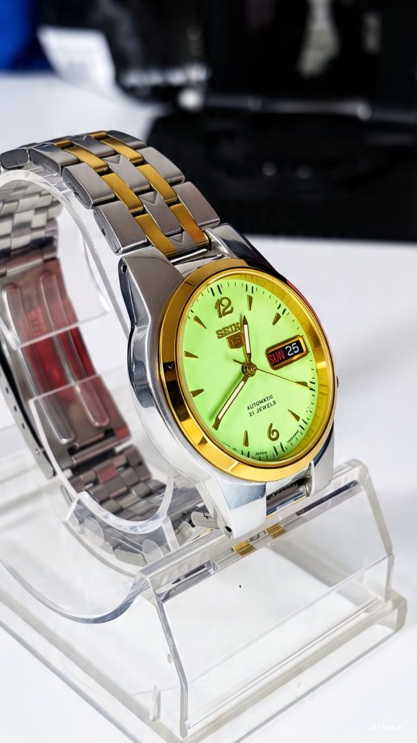 Seiko 5 Automatic 21 Jewels Two-Tone Watch (Category: Men's Watches) located in Caloocan City. Submitted by imlei (Listing ID 1470301818, Image 2). Description: - Brand/Model: Seiko 5 Automatic Watch - Movement: Reliable 21 jewels automatic movement with visible exhibition case back - Dial: Striking bright yellow-green dial with prominent 6 and 12 numerals - Features: Convenient day and date display at the 3 o'clock position - Design: Two-tone st