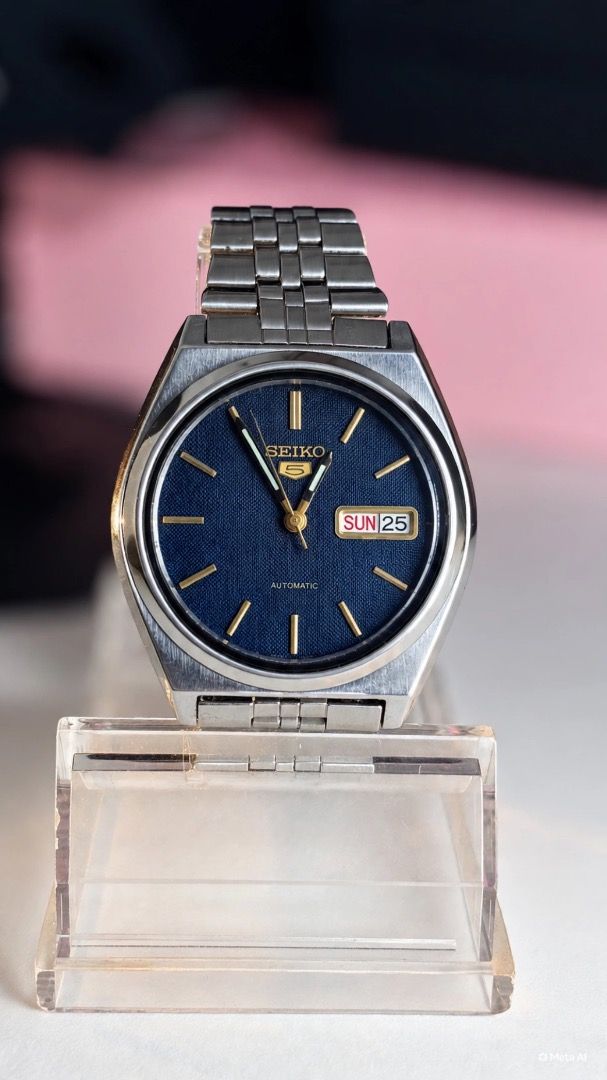 Seiko 5 Automatic Textured Blue Dial Watch (Category: Men's Watches) located in Caloocan City. Submitted by imlei (Listing ID 1470301967, Image 1). Description: - Brand/Model: Seiko 5 Automatic Watch - Dial: Striking textured blue dial with gold hands and hour markers - Features: Convenient day-date window at 3 o'clock - Build: Durable silver-tone stainless steel case and matching metal bracelet - Style: Classic vintage design, perfect as a relia