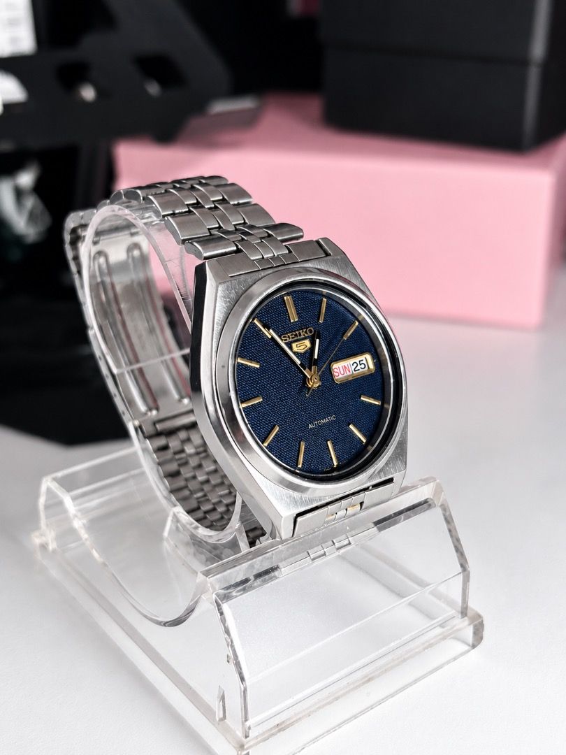 Seiko 5 Automatic Textured Blue Dial Watch (Category: Men's Watches) located in Caloocan City. Submitted by imlei (Listing ID 1470301967, Image 2). Description: - Brand/Model: Seiko 5 Automatic Watch - Dial: Striking textured blue dial with gold hands and hour markers - Features: Convenient day-date window at 3 o'clock - Build: Durable silver-tone stainless steel case and matching metal bracelet - Style: Classic vintage design, perfect as a relia
