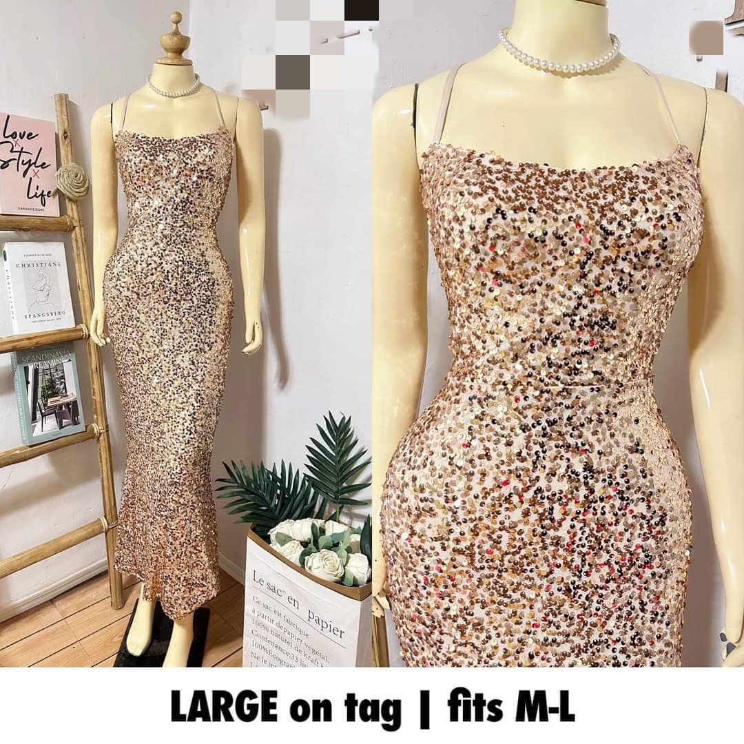 Gown (Category: Evening dresses & gowns) located in Cavite. Submitted by sassycorner_26 (Listing ID 1470322477, Image 1). Description: - Style: Gold sequin mermaid gown with bodycon fit and flared hem - Details: Spaghetti straps, sexy criss-cross lace-up back - Size: Tagged Large, best fits Medium to Large - Condition: Excellent, super sparkly and eye-catching - Perfect for: Parties, proms, and night outs Mode of Payment: ✅ Gcash ✅ Bank Transfer 