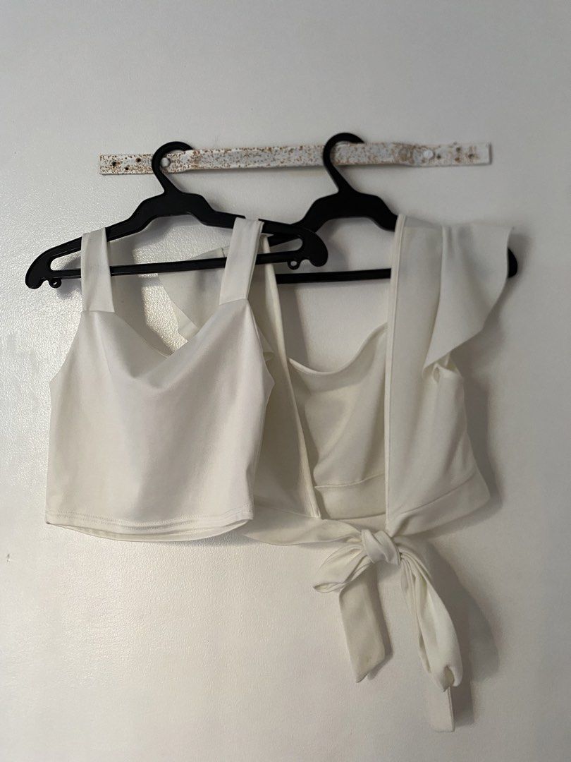 Set of two white crop tops (Category: Shirts) located in Caloocan City. Submitted by juliana_25a (Listing ID 1470231690, Image 2). Description: - Set of 2 versatile white crop tops - Top 1: Thick straps, ruched sweetheart neckline with a tiny bow - Top 2: Short ruffled sleeves, square neckline, tie-front hem detail - Condition: Clean and ready to wear - Ideal basic pieces for warm weather outfits.